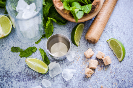 Preparing refreshing Cuban Mojito with rum,lime and mint.の写真素材