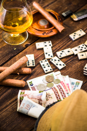 cuban domino game for money, cuban cigars and hat on tableの写真素材