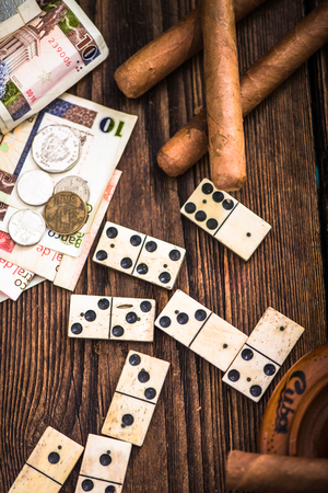 cuban cigars, domino and money on table, overheadの写真素材