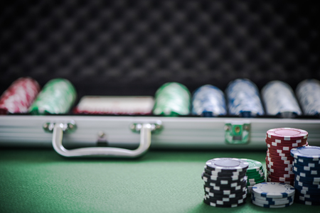 casino chips and metal case, blurred backgroundの写真素材