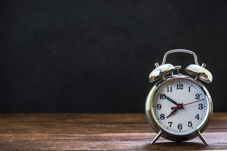 retro alarm clock with black notice board in background