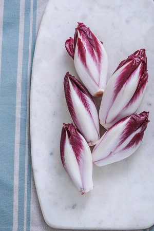 red crunchy chickory on marble boardの写真素材