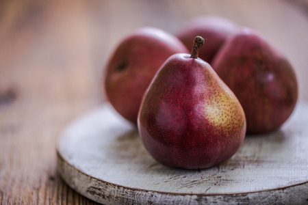red pears on rustic boardの写真素材