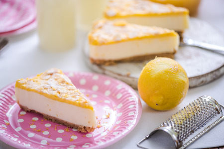 serving lemon cheesecake on pastel pink plateの写真素材