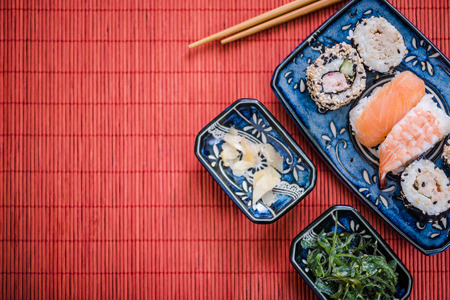 japanese food sushi background, overhead with copy space on bamboo matの写真素材