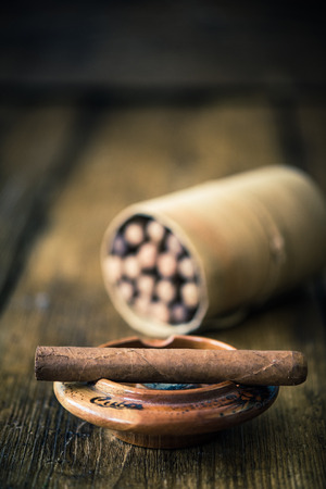 handmade cigar on wooden table, moody dark imageの写真素材