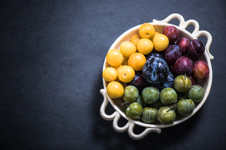bowl with plums, autumn seasonal fruit from local marketの写真素材