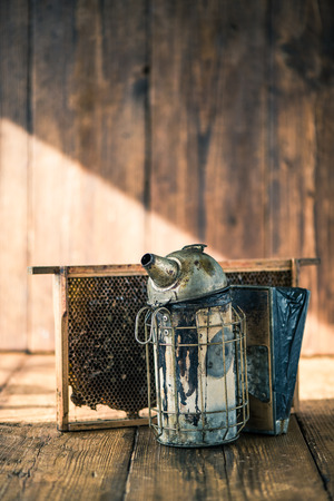 Beekeeper vintage tools, smoker and honey combの写真素材