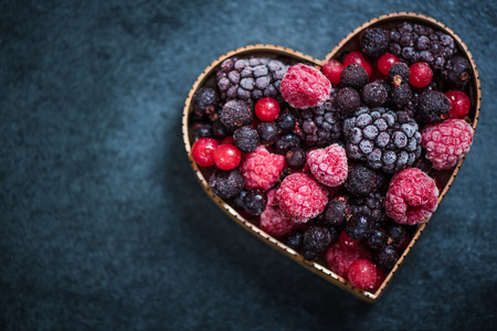 Frozen berries in heart symbol shape