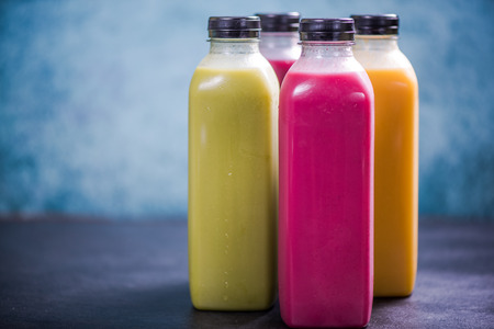 Colorful and vivid smoothies in plastic bottles