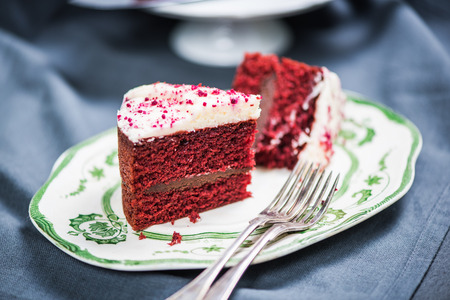 Slice of red velvet sponge cake on serving plate