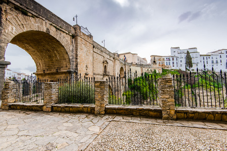 White houses hanging from cliffs in Ronda,Spain. View include famous  Puente Nuewo New Bridgeのeditorial素材