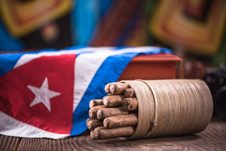 Cuban cigar in ashtray on wooden table, items related to travel to Cuba.の写真素材