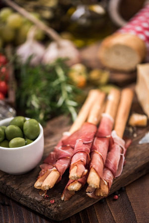 Bread sticks with prosciutto ham,italian tapa food.の写真素材