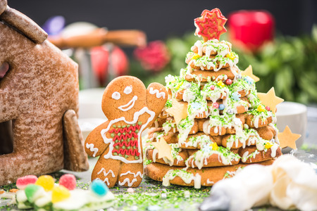 Making gingerbread house and sweet Christmas tree in creative artisan bakery