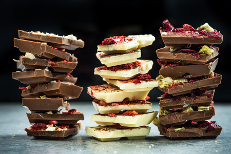 Handmade artisan chocolate pieces in stacks.の写真素材