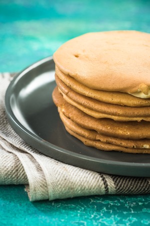 Homemade pancakes stack in pile on plate.の写真素材