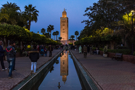 Marrakech,Morocco - January 24th 2018: Moroccan people walking in gardens by Koutoubia Mosque in Marrakesh,Morocco.のeditorial素材