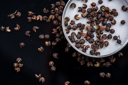 Dried Tumit pepper seeds on black background.の写真素材