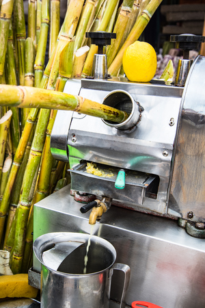 Marrakech,Morocco - January 2018: Street food vendor making fresh pressed cane juice in Morocco.のeditorial素材