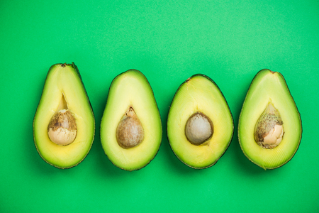 Avocado flat lay on green pastel background. Food concept