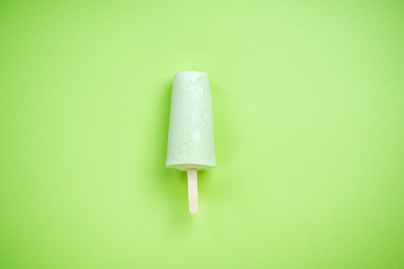 Green ice cream on green pastel background.の写真素材