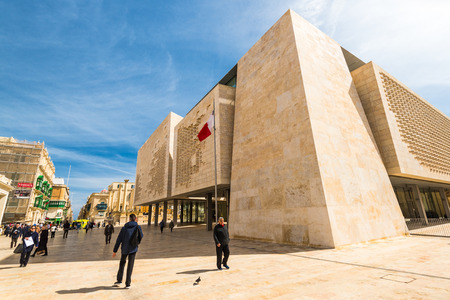 VALLETTA, MALTA - MARCH , 2018: People walking past Valletta Parliament building at sunny day.のeditorial素材