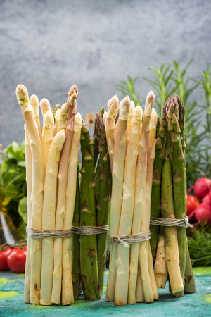 Bunch of asparagus standing on kitchen table.の写真素材