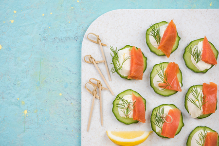 Smoked salmon, cottage cheese and cucumber snack for garden party.の写真素材