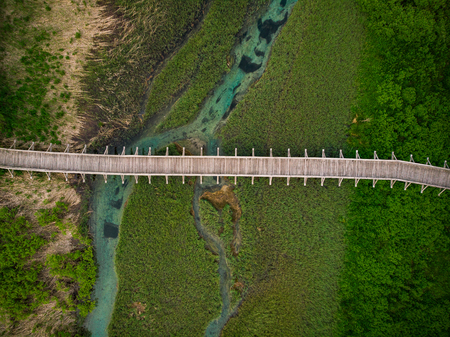 Wooden footbridge in Zelenci Natural Reserve,Slovenia. Aerial drone view,top down.の写真素材