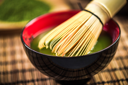 Bamboo whisk making Matcha green tea