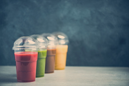 Colorful smoothie selection on dark slate backgroundの写真素材