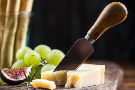 Parmesan cheese pieces cut by cheese knife.の写真素材