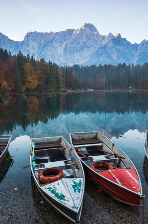 Colorful boats at scenic Fusine Lake in Italian Alps.の写真素材