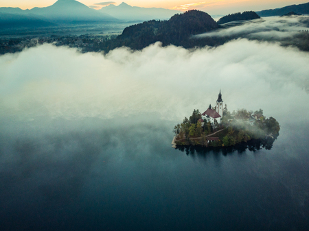 Bled castle on lake in foggy autumn morning,SLovenia.の写真素材