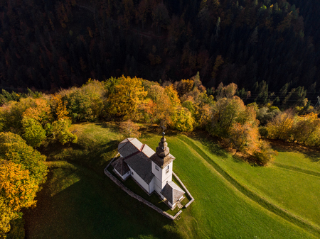 Aerial view of rural church or chapel in Slovenia at autumn.の写真素材