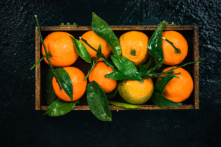 Tangerines or clementines in wooden crate.の写真素材