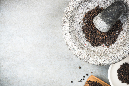 Black peppercorn seed in granite mortar or pestle.の写真素材