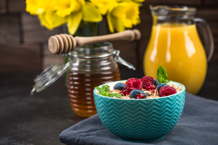 Muesli in bowl with fresh berry fruits.の写真素材