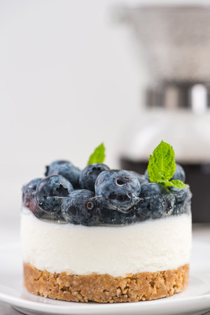 Blueberry cheesecake, serving portion with fresh mint.の写真素材