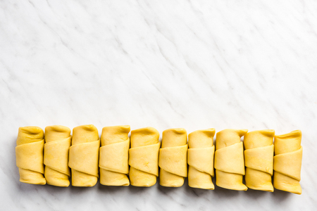 Mini croissants in row on marble table.の写真素材