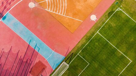 Athletic stadium and football grass pitch, aerial top down view