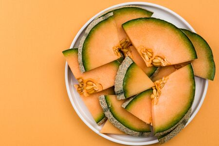 Sliced Cantaloupe Melon Served on Plate, Pastel Background , Border Background.の写真素材