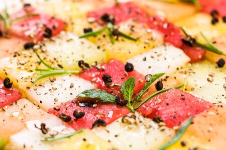Watermelon and Melon Cubes with HErbs and Spices, Top View, Creative Party Food Serving.の写真素材