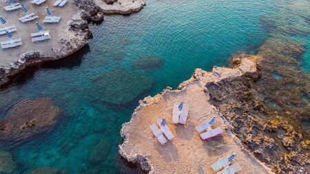 Chairs on Beach by Turquoise Water on Greek Island, Drone View.の写真素材