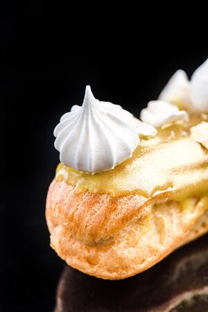 French Artisan Eclair on Black Reflective Background,Copy Space. Patisserie Bakery Product.の写真素材