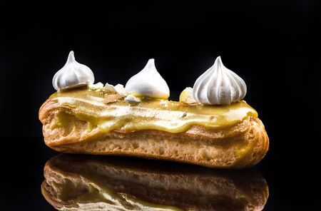 French Artisan Eclair on Black Reflective Background,Copy Space. Patisserie Bakery Product.の写真素材