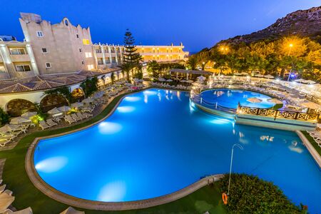 RHODES, GREECE - JULY 24, 2019: Kalithea Mare Palace, Luxury Hotel Resort with Swimming Poll Illuminated at Sunriseのeditorial素材