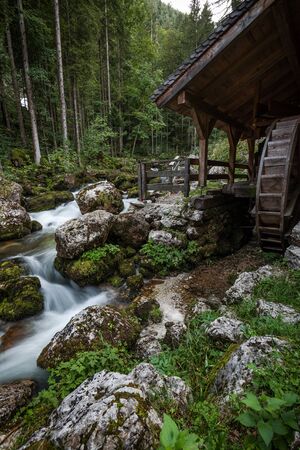 Wooden Mill at Creek by Gollinger Waterfall in Austria. Autumn Season. Long Exposure Photo.の写真素材