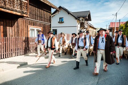 SZCZAWNICA,POLAND - OCTOBER 12, 2019: Polish Shepherds in Traditional Festive Clothing Leading Sheeps Trough Village. Celebrating "Redyk" Day When Sheeps Going Back To Village for Winter from Grazingのeditorial素材